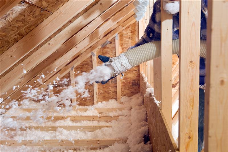 Cellulose insulation being added to an attic
